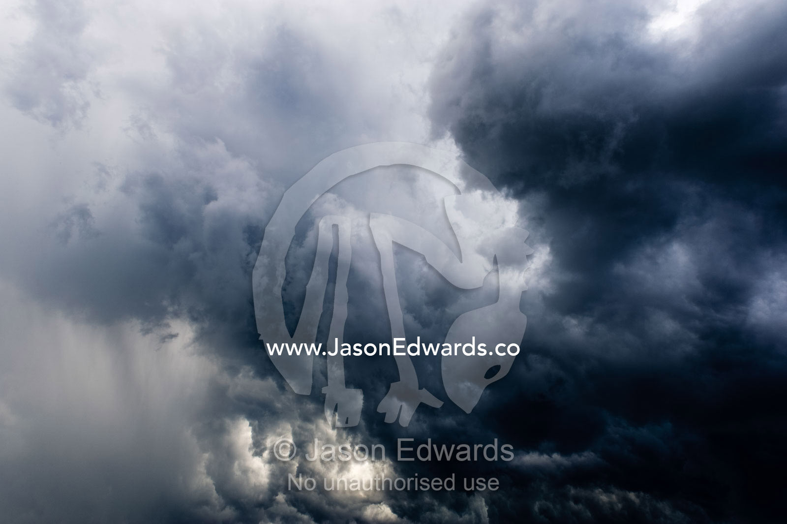 The billowing clouds of a menacing tropical rainstorm darkens the sky. Gladstone, Queensland, Australia.