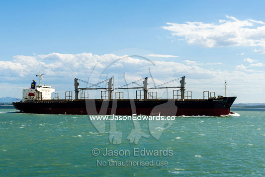 A handymax size ship with cranes suitable to carry logs on deck with permanent stanchions on the sides. Can be used to carry most dry bulk cargoes, such as wheat, calcite, alumina, dead burned magnesia. Gladstone, Queensland, Australia.