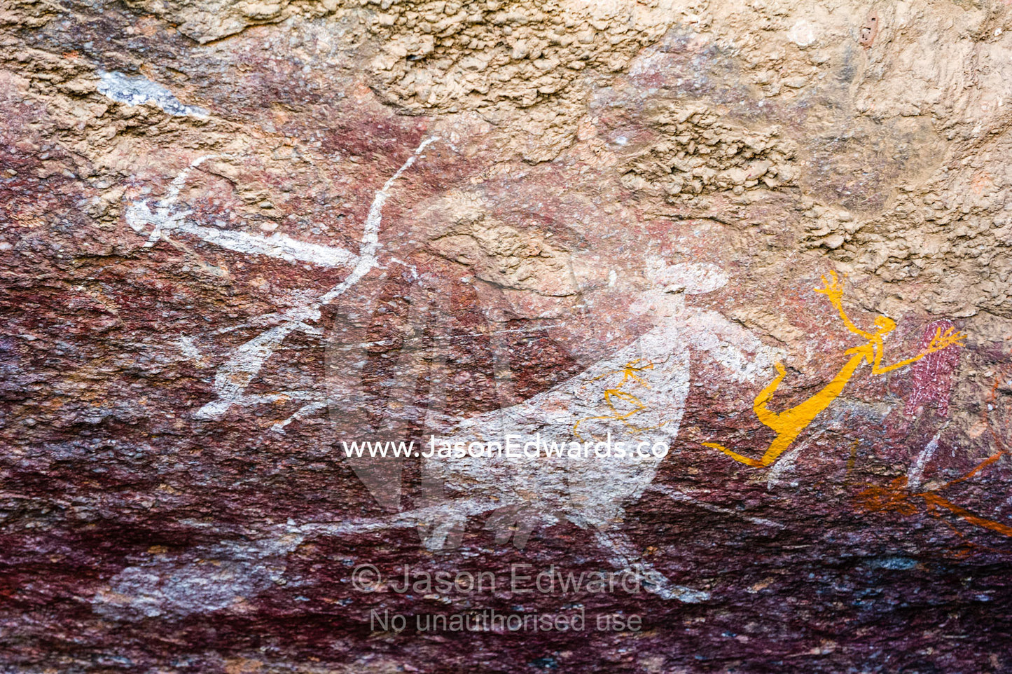 An ancient image of a kangaroo and human figures painted in an Aboriginal rock painting art gallery. Burrunggui, Nourlangie Rock, Arnhem Land, Kakadu National Park, Northern Territory, Australia.