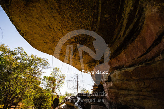 A cliff overhang on a sandstone escarpment protects an ancient Aboriginal rock painting art gallery. Ubirr, Kakadu National Park, Northern Territory, Australia.