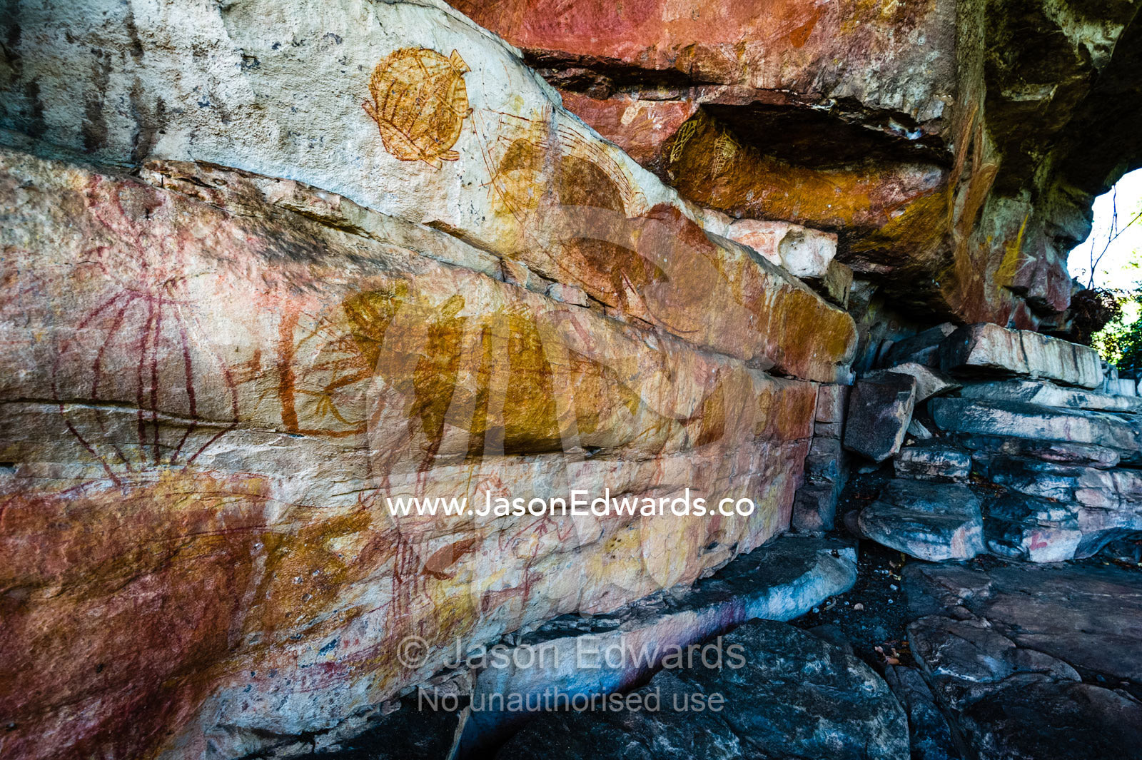 A cliff overhang on a sandstone escarpment protects an ancient Aboriginal rock painting art gallery. Ubirr, Kakadu National Park, Northern Territory, Australia.