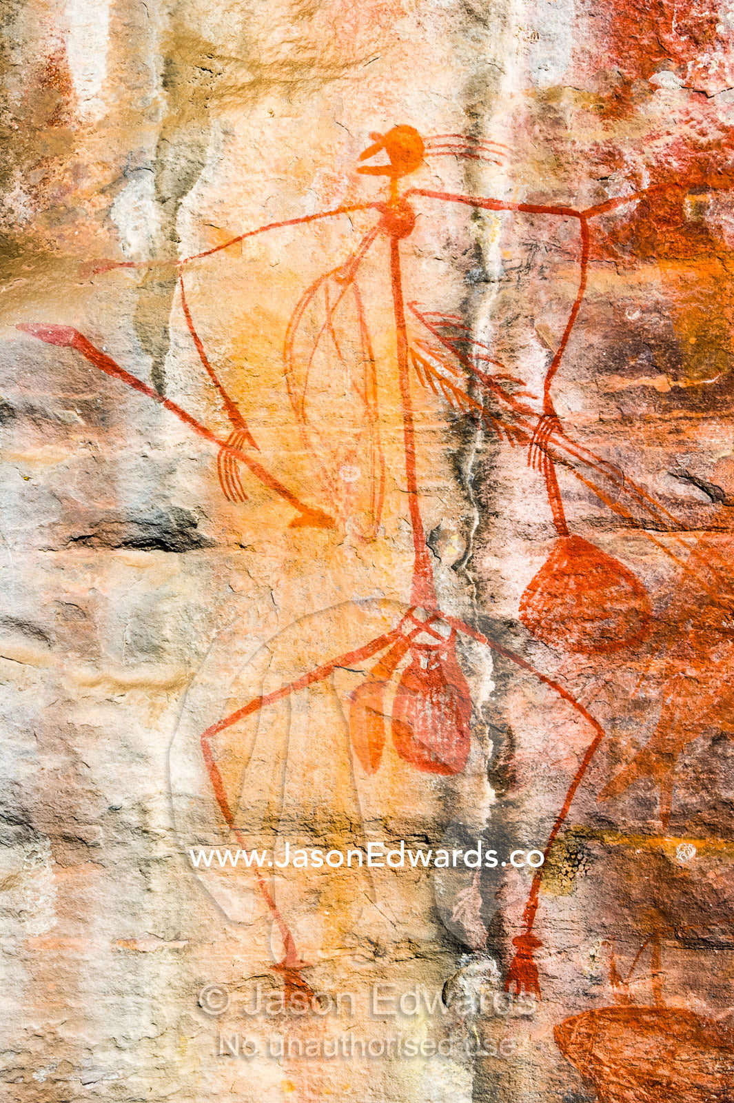 Aboriginal rock painting of a Mabuyu figure hunting in a gallery on a sandstone escarpment. Ubirr, Kakadu National Park, Northern Territory, Australia.