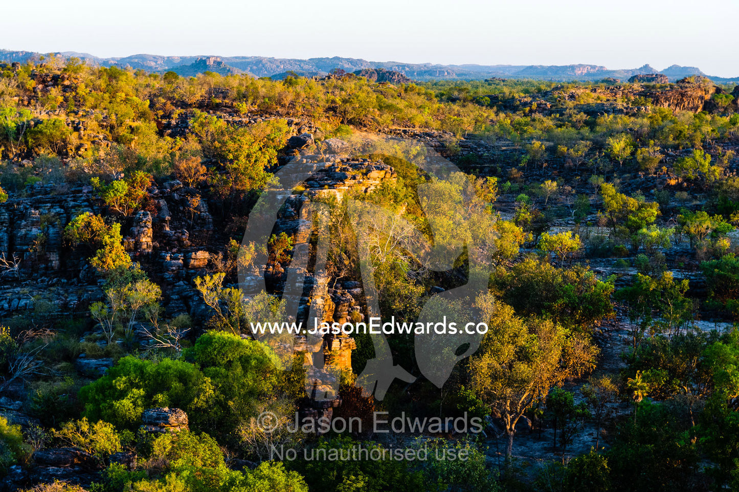 Sunset falls over a rugged Kombilgie sandstone stone country. Ubirr, Kakadu National Park, Northern Territory, Australia.