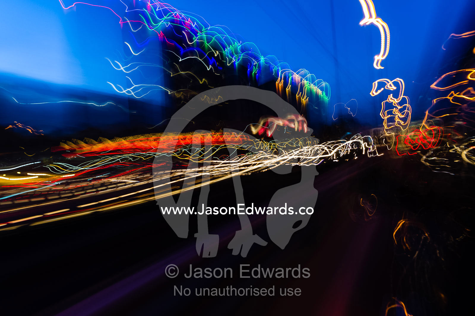 The blurred headlights of cars racing along a city street. Tehran, Tehran Province, Islamic Republic of Iran.