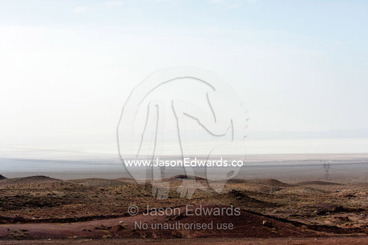 A salt pan stretches across the desert horizon. Qom Province, Islamic Republic of Iran.