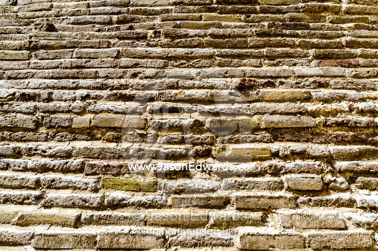 A textured detail of the handmade bricks of an ancient cistern containing town water. Kashan, Isfahan Province, Islamic Republic of Iran.