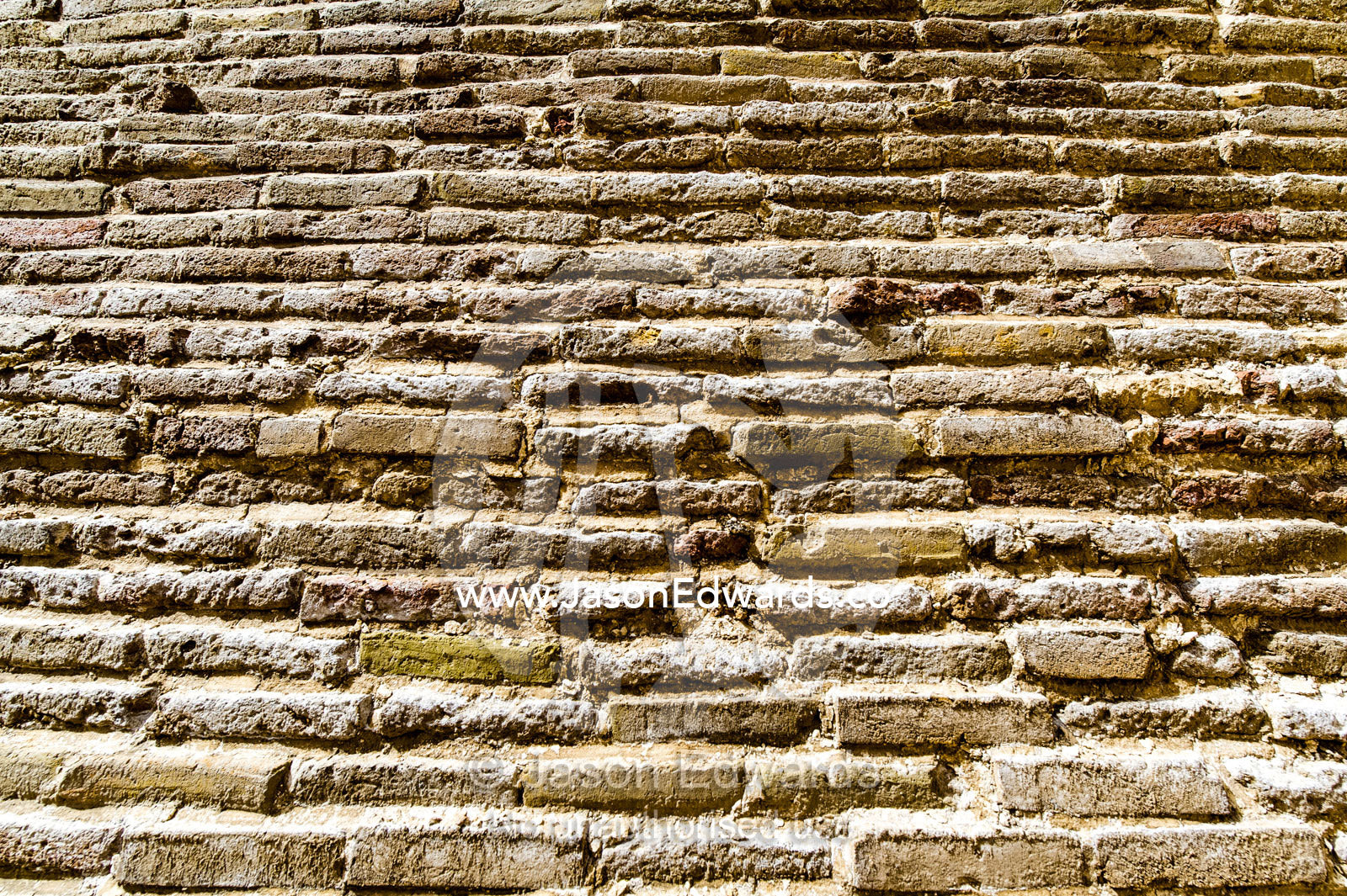 A textured detail of the handmade bricks of an ancient cistern containing town water. Kashan, Isfahan Province, Islamic Republic of Iran.