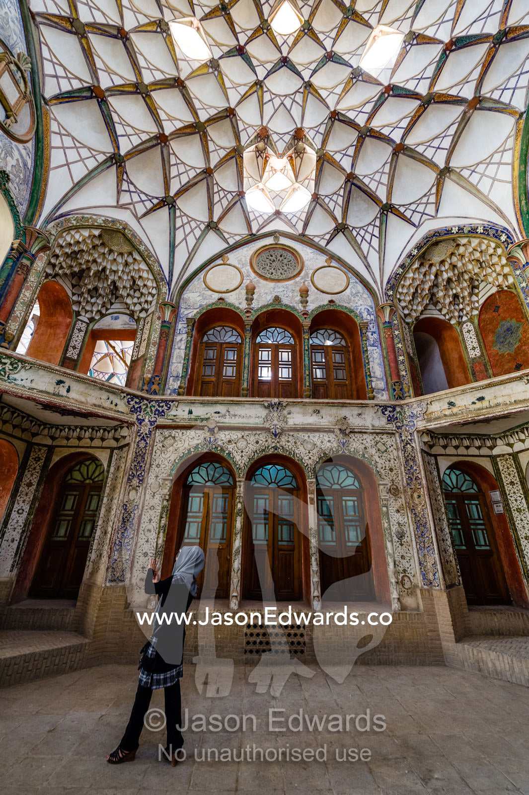 An Iranian tourist photographs the vaulted spiralling geometric ceiling of the Borujerdis House. Borujerdis House, Kashan, Isfahan Province, Islamic Republic of Iran.