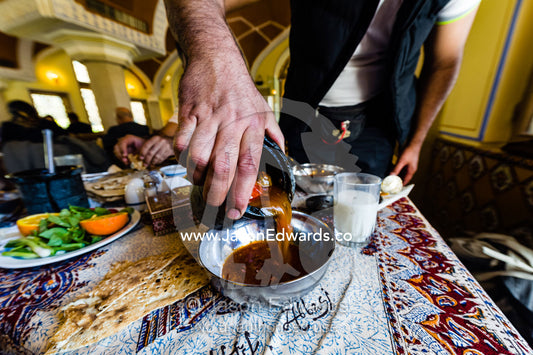 A man pouring dizi a traditional Iranian stew. The Abbasi Hotel, Isfahan, Isfahan Province, Islamic Republic of Iran.