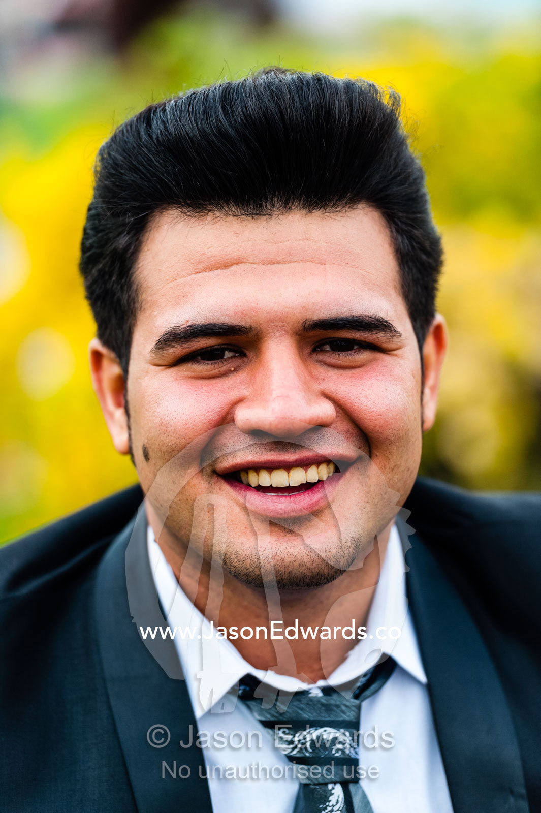 A newly married groom laughing whilst on New Year holiday. Naqsh-e Jahan Square, Isfahan, Isfahan Province, Islamic Republic of Iran.