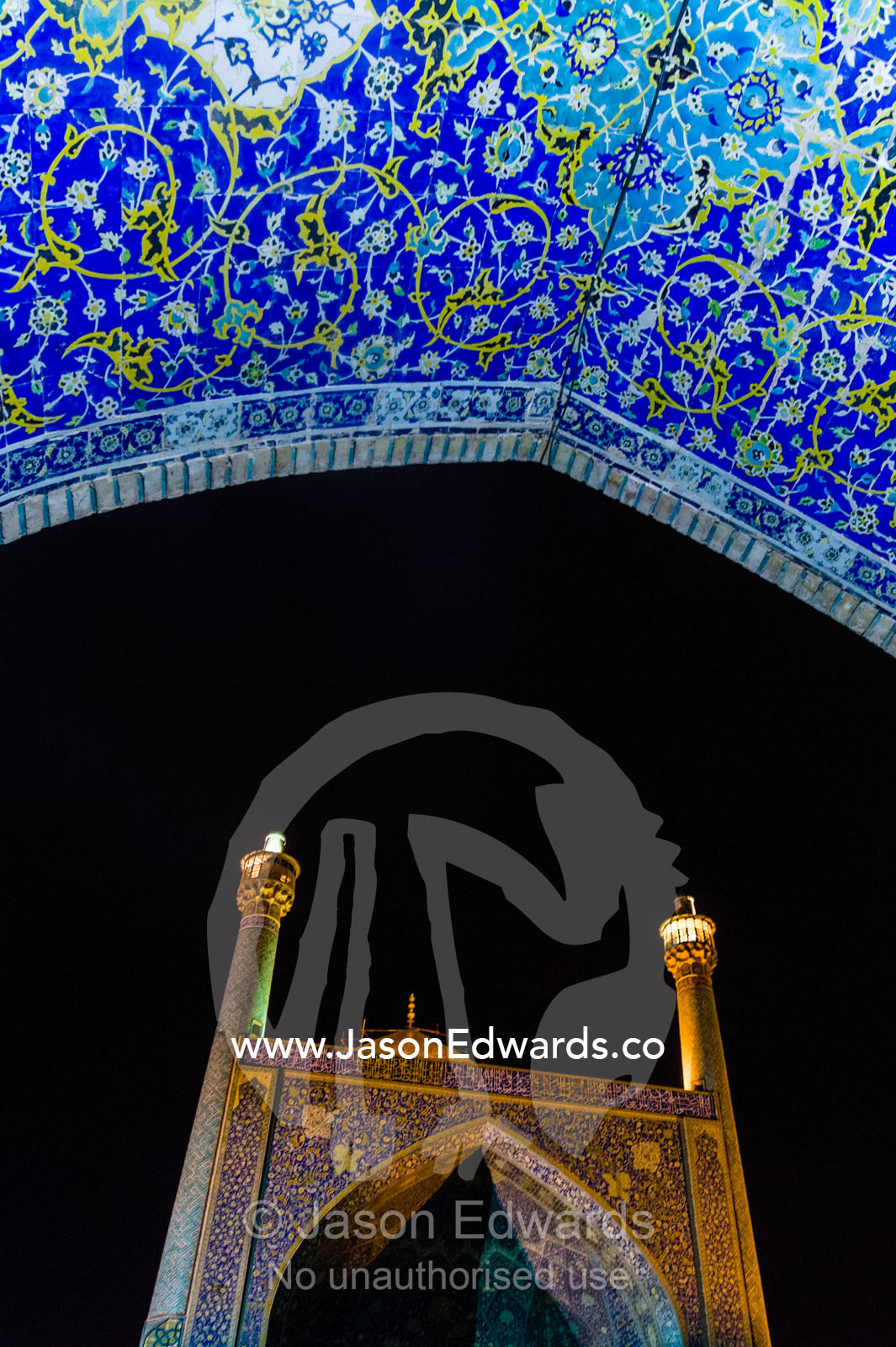 The courtyard and vaulted iwan of the Shah Mosque illuminated at night. Shah Mosque, Isfahan, Isfahan Province, Islamic Republic of Iran.