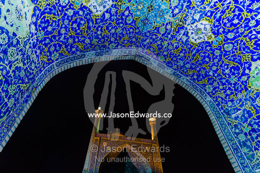 The courtyard and vaulted iwan of the Shah Mosque illuminated at night. Shah Mosque, Isfahan, Isfahan Province, Islamic Republic of Iran.