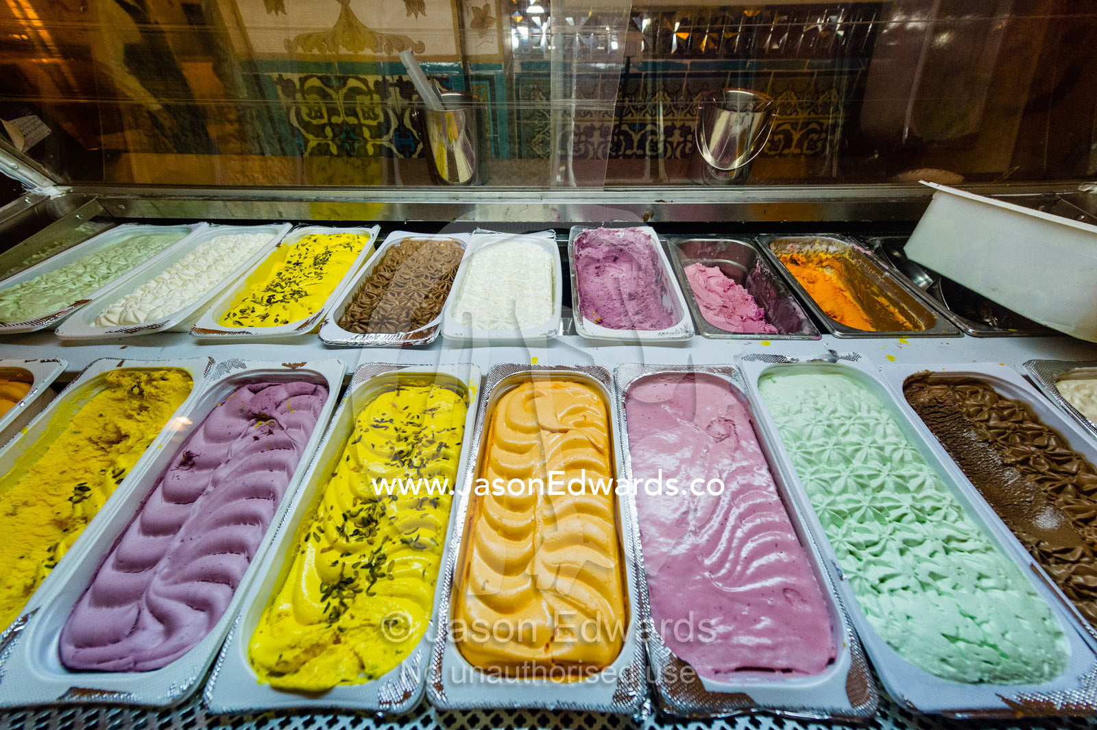 Colourful tubs of icecream in a variety of flavors for sale in a shop. Isfahan, Isfahan Province, Islamic Republic of Iran.