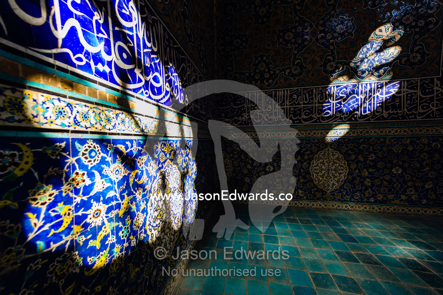 Sunbeams put spotlights on the tiled walls of the Sheikh Lotfollah Mosque. Sheikh Lotfollah Mosque, Naqsh-e Jahan Square, Isfahan, Isfahan Province, Islamic Republic of Iran.