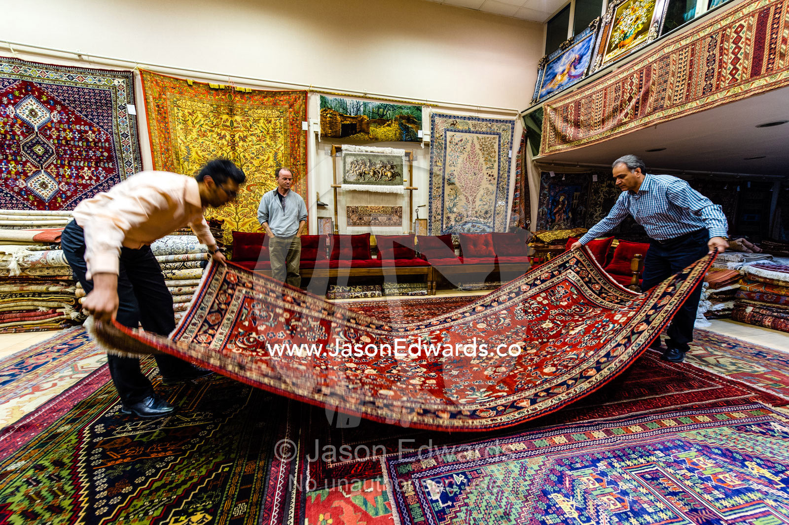 Persian carpet merchants display their goods in an ancient Bazaar. Isfahan Bazaar, Isfahan, Islamic Republic of Iran.