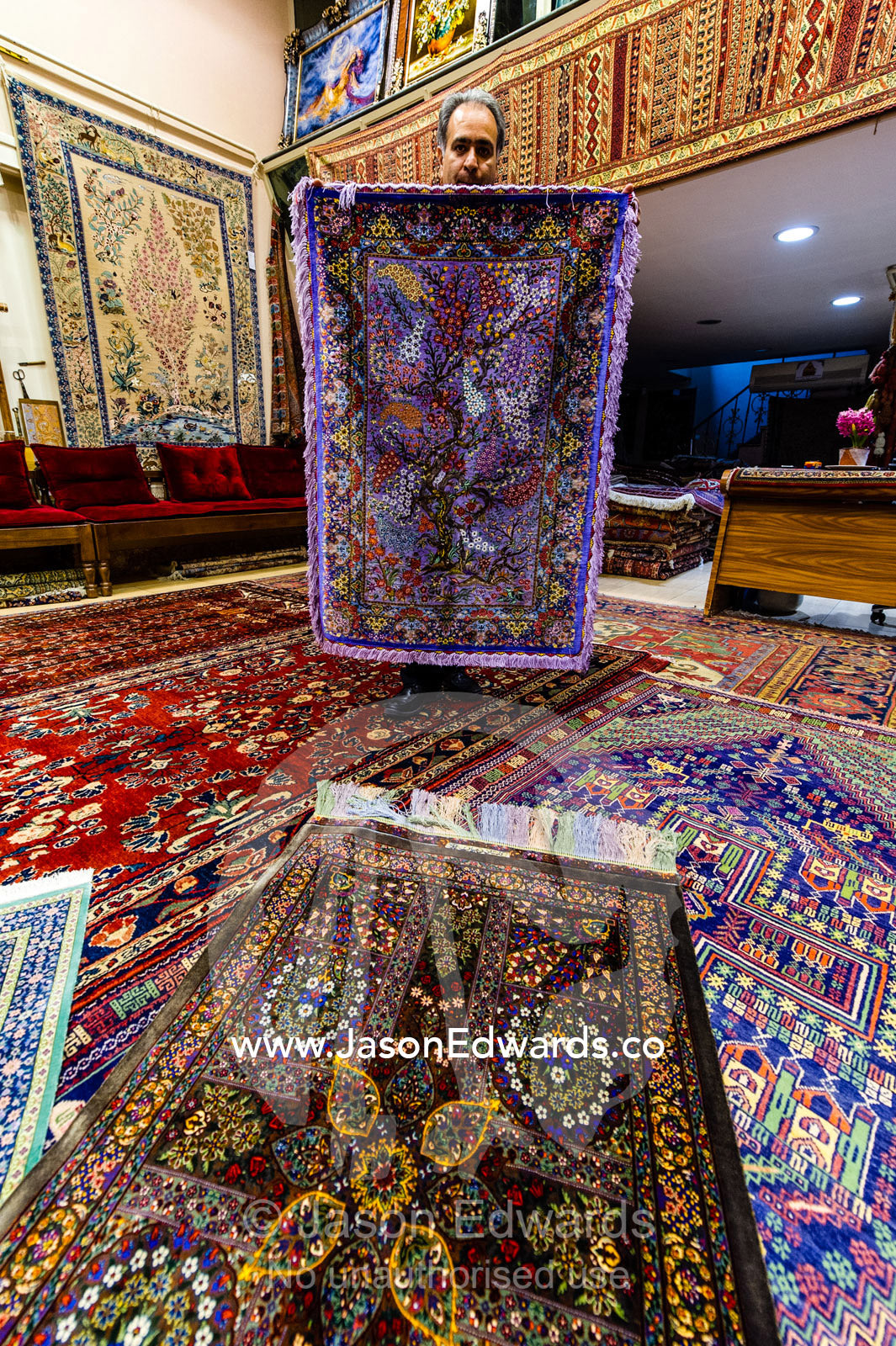 Persian carpet merchants display their goods in an ancient Bazaar. Isfahan Bazaar, Isfahan, Islamic Republic of Iran.