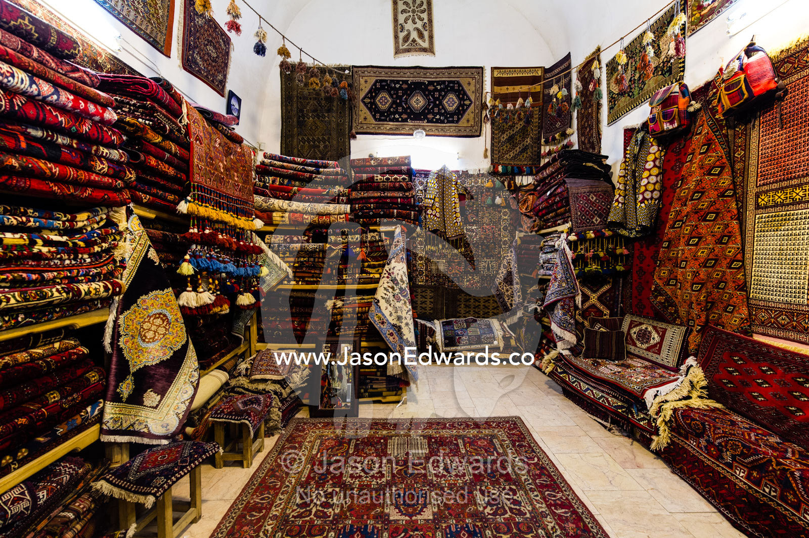 The ordered chaos of a Persian carpet shop in an ancient bazaar. Isfahan Bazaar, Isfahan, Islamic Republic of Iran.