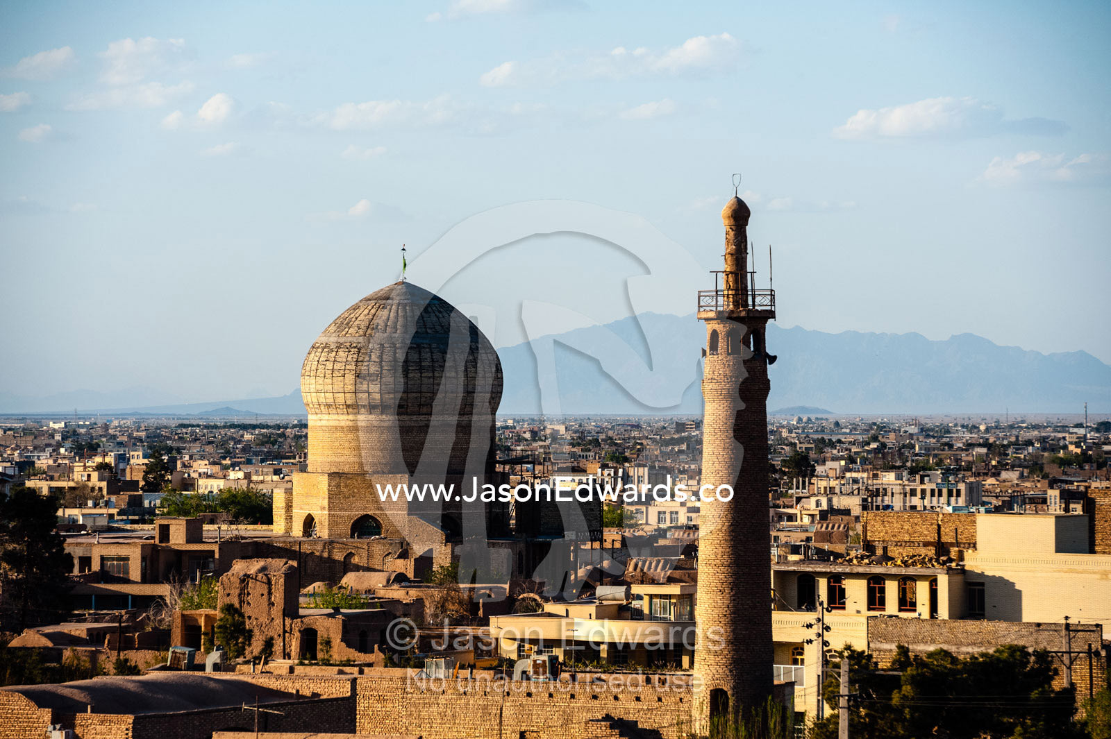 A minaret rises above an ancient city skyline to call people to prayer. Meybod, Meybod County, Yazd Province, Islamic Republic of Iran.