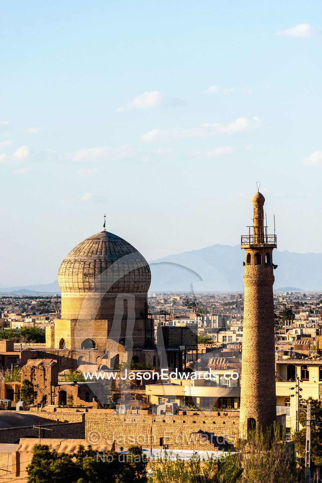 A minaret rises above an ancient city skyline to call people to prayer. Meybod, Meybod County, Yazd Province, Islamic Republic of Iran.