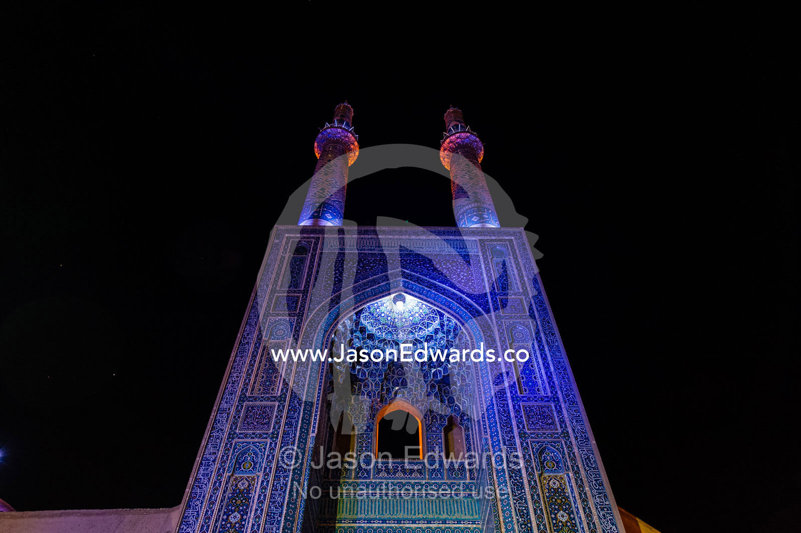 The iridescent blue minarets above the vaulted iwan to the Jame Mosque. Jame Mosque of Yazd, Yazd, Yazd Province, Islamic Republic of Iran.