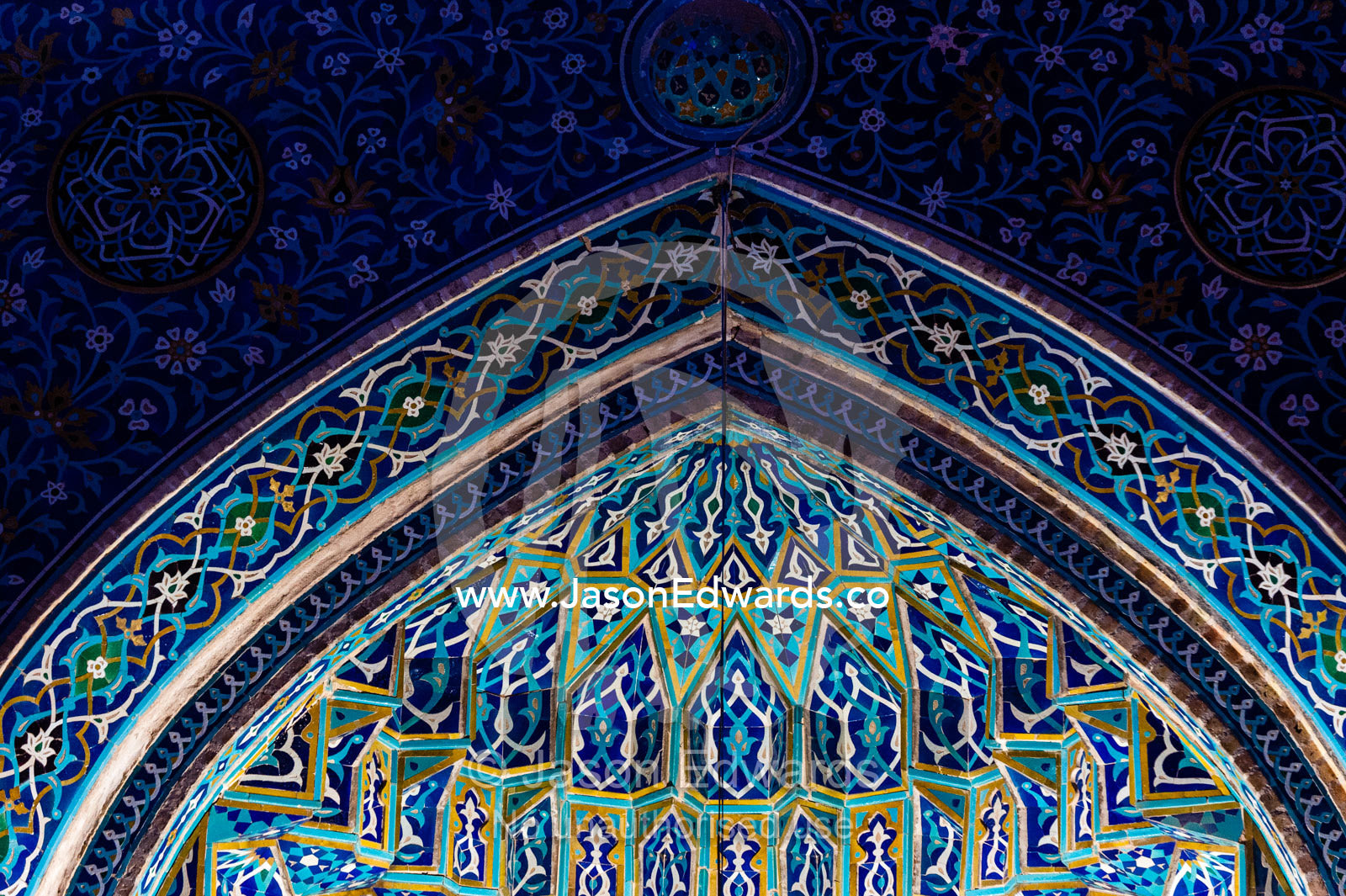 The iridescent blue geometric muqarnas tiled entrance to the Jame Mosque prayer hall. Jame Mosque of Yazd, Yazd, Yazd Province, Islamic Republic of Iran.