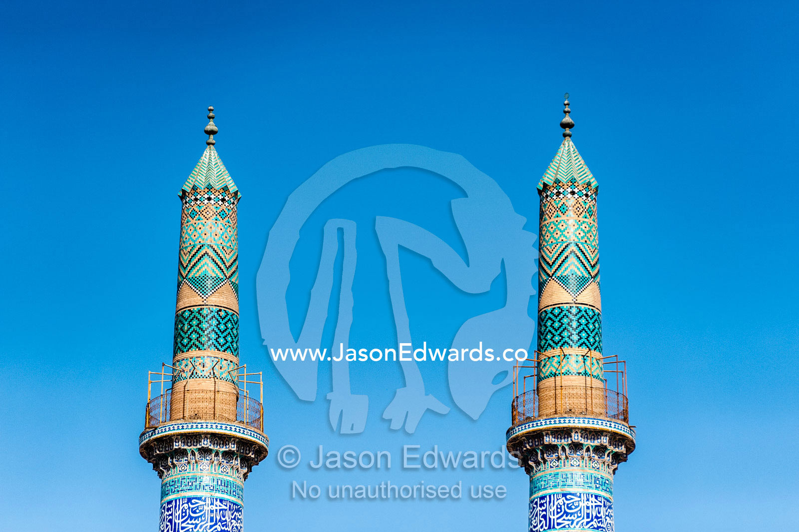 The towering blue tiled minarets of the Jame Mosque rise into a clear blue sky. Jame Mosque of Yazd, Yazd, Yazd Province, Islamic Republic of Iran.