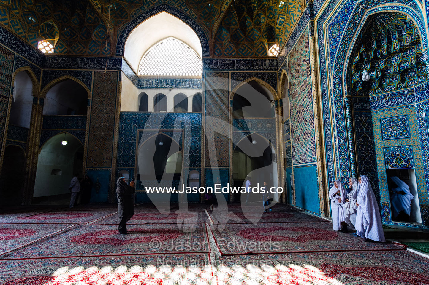 An Iranian tourist photographs his family in the prayer hall of the Jame Mosque. Jame Mosque of Yazd, Yazd, Yazd Province, Islamic Republic of Iran.
