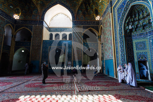 An Iranian tourist photographs his family in the prayer hall of the Jame Mosque. Jame Mosque of Yazd, Yazd, Yazd Province, Islamic Republic of Iran.