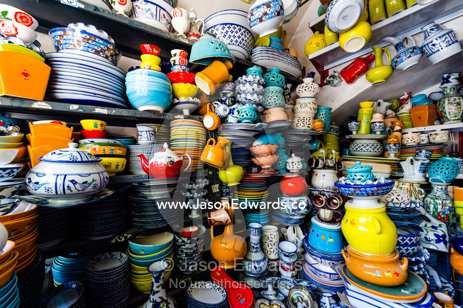 The ordered chaos of a pottery shop stacked high with ceramics. Yazd, Yazd Province, Islamic Republic of Iran.