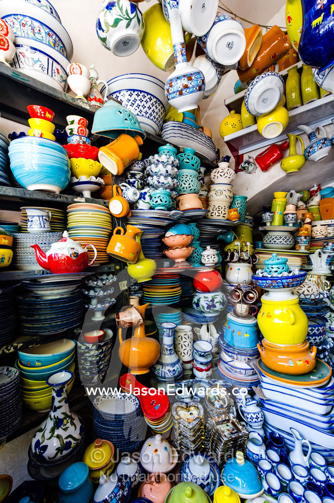 The ordered chaos of a pottery shop stacked high with ceramics. Yazd, Yazd Province, Islamic Republic of Iran.