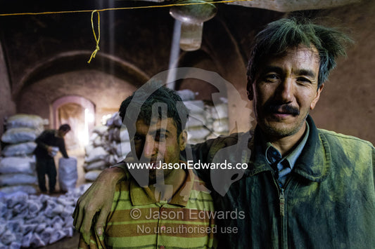 The exhausted faces of friends working in an ancient henna mill. Yazd, Yazd Province, Islamic Republic of Iran.
