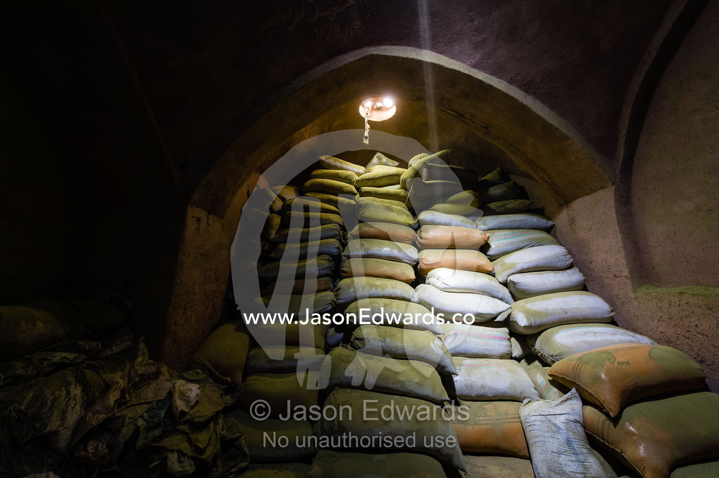 Sunrays touch bags of henna powder stored in an ancient henna mill. Yazd, Yazd Province, Islamic Republic of Iran.