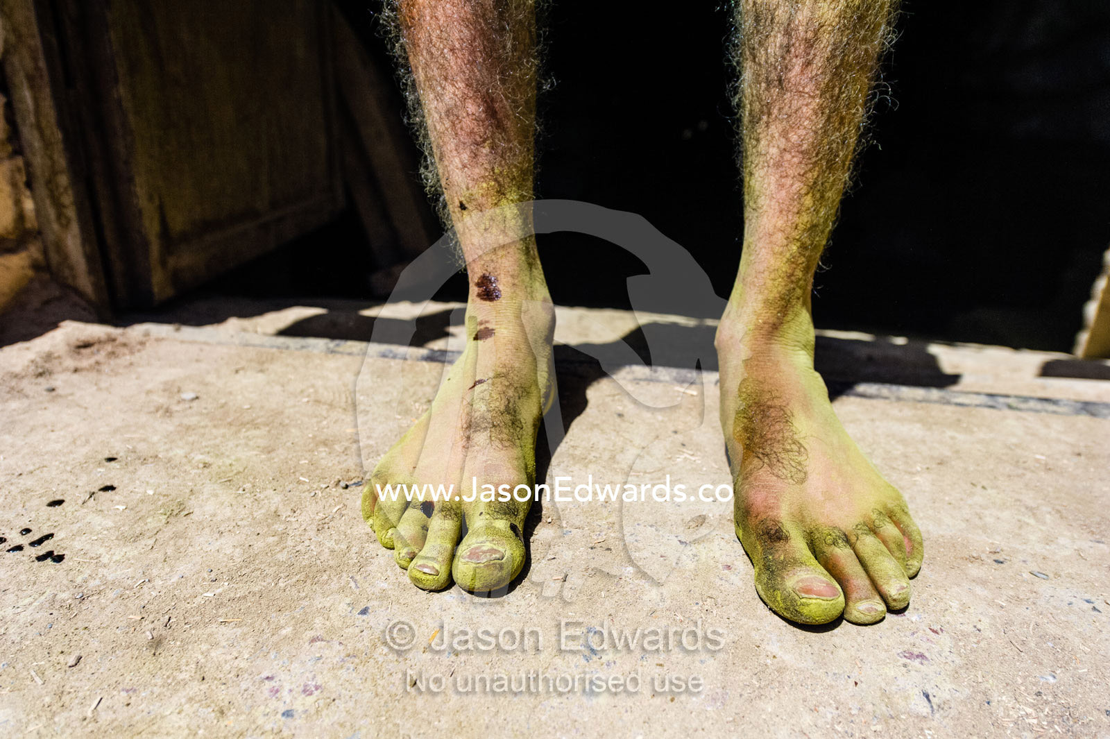 The henna stained feet of a labourer working in an ancient henna mill. Yazd, Yazd Province, Islamic Republic of Iran.