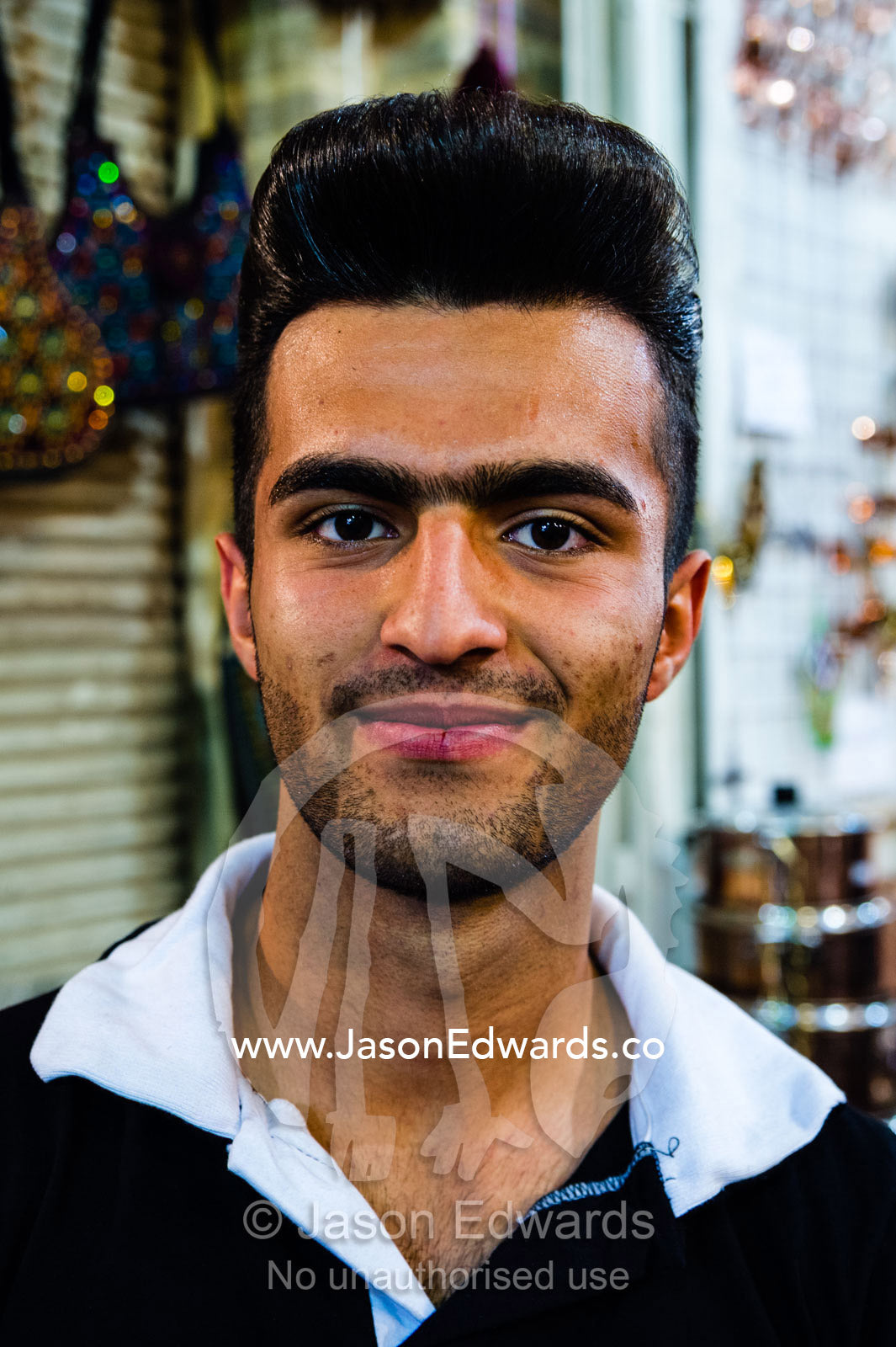 An Iranian Bazaar vendor with a 1950s quiff hairstyle. Vakil Bazaar, Shiraz, Islamic Republic of Iran.