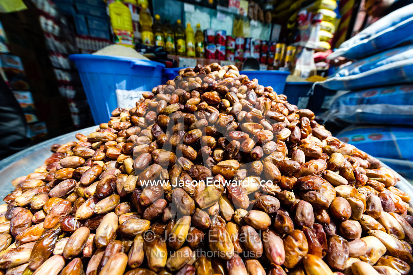 A large pile of dates for sale at a food market in an ancient bazaar. Saraye Moshir, Shiraz, Islamic Republic of Iran.