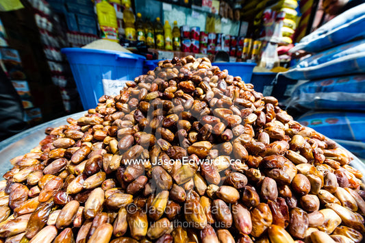 A large pile of dates for sale at a food market in an ancient bazaar. Saraye Moshir, Shiraz, Islamic Republic of Iran.