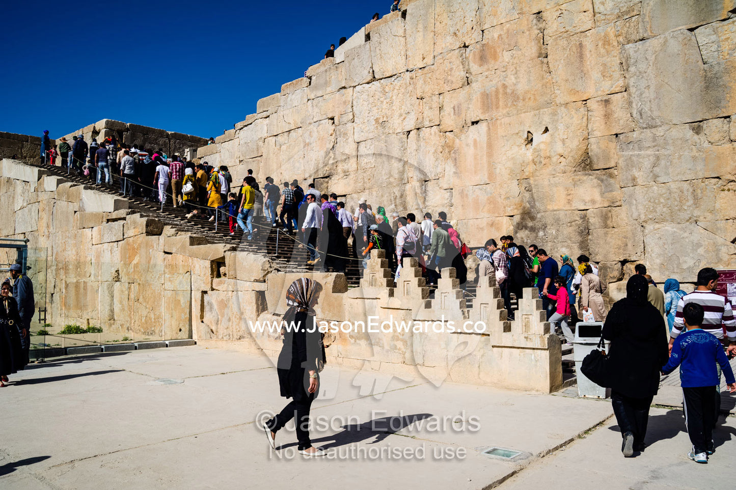 Crowds of Iranian tourists gather at the Gate of All Nations in Persepolis. Persepolis, Shiraz, Fars Province, Islamic Republic of Iran.