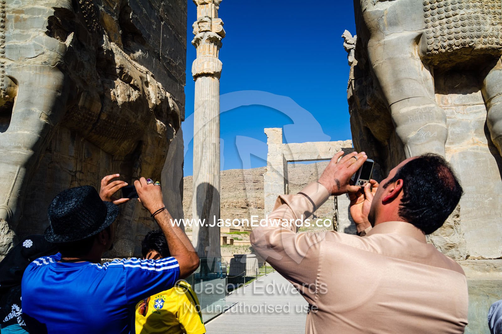 Iranian tourists photograph protective gods known as Lamassu at the Gate of All Nations in Persepolis. Persepolis, Shiraz, Fars Province, Islamic Republic of Iran.