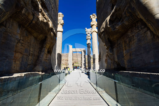 A boardwalk passing between towering protective gods known as Lamassu at the Gate of All Nations in Persepolis. Persepolis, Shiraz, Fars Province, Islamic Republic of Iran.
