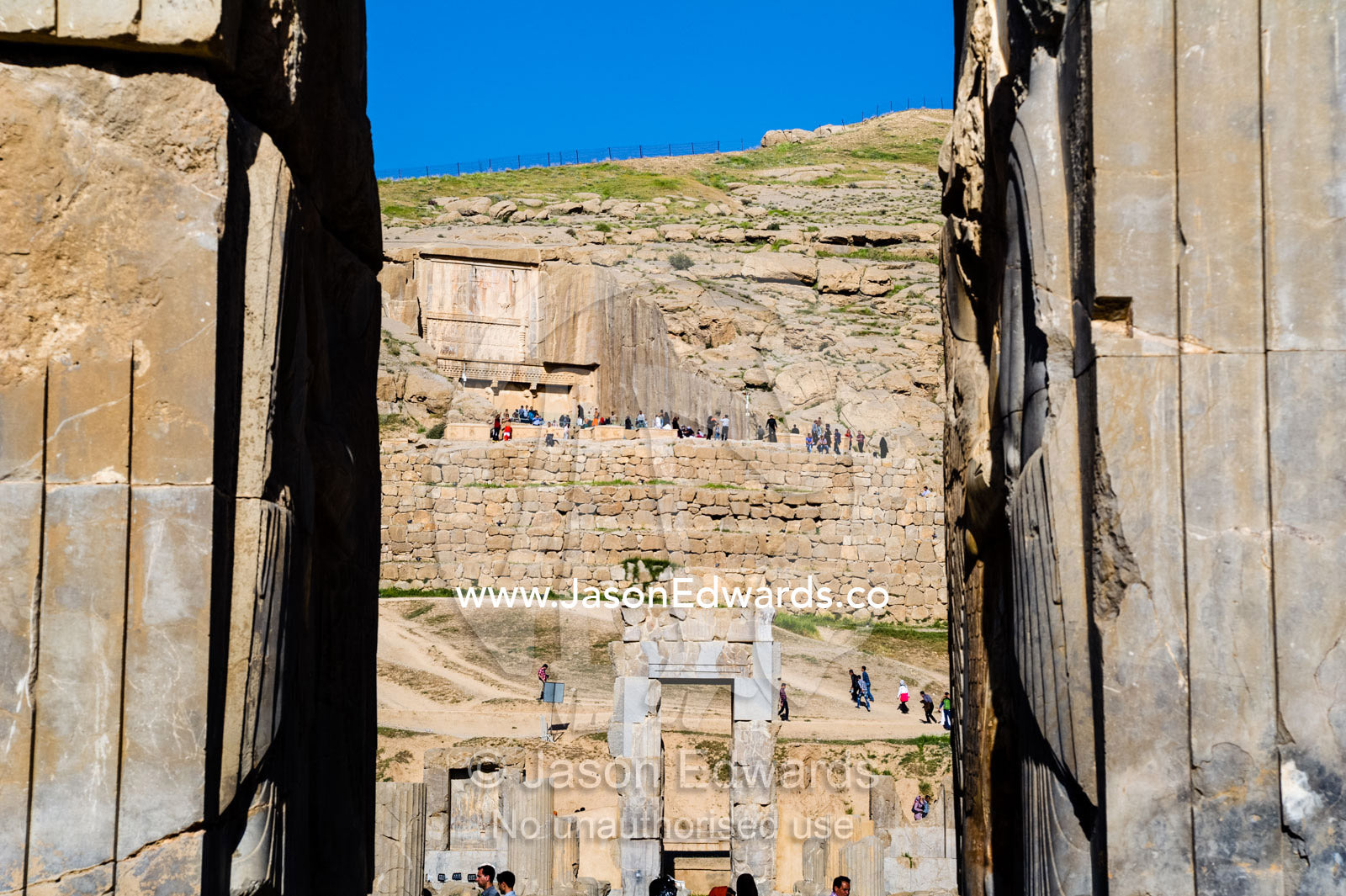 Looking through a stone gate at the ancient ruins of Persepolis. Persepolis, Shiraz, Fars Province, Islamic Republic of Iran.