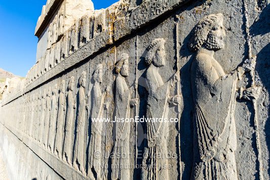 A limestone frieze of immortal guards carrying spears carved into a stone wall at Persepolis. Persepolis, Shiraz, Fars Province, Islamic Republic of Iran.