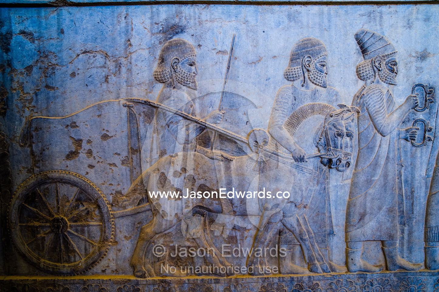Carved bas reliefs depict envoys of the subject nations of Persia bringing gifts to the King. Persepolis, Shiraz, Fars Province, Islamic Republic of Iran.