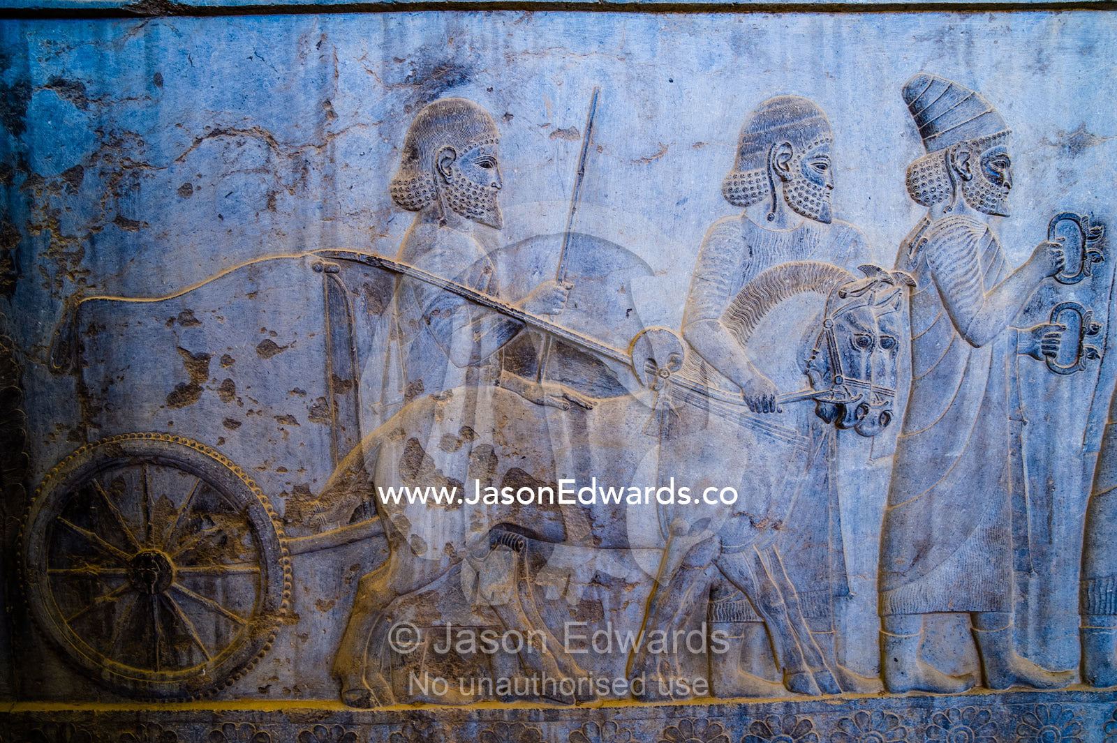 Carved bas reliefs depict envoys of the subject nations of Persia bringing gifts to the King. Persepolis, Shiraz, Fars Province, Islamic Republic of Iran.