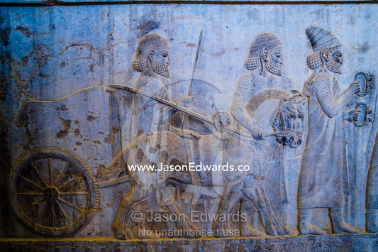 Carved bas reliefs depict envoys of the subject nations of Persia bringing gifts to the King. Persepolis, Shiraz, Fars Province, Islamic Republic of Iran.