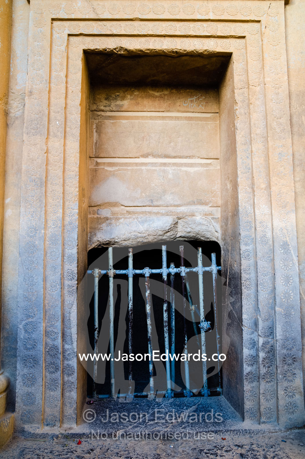 A steel gate prevents people from accessing a King's tomb at Persepolis. Persepolis, Shiraz, Fars Province, Islamic Republic of Iran.