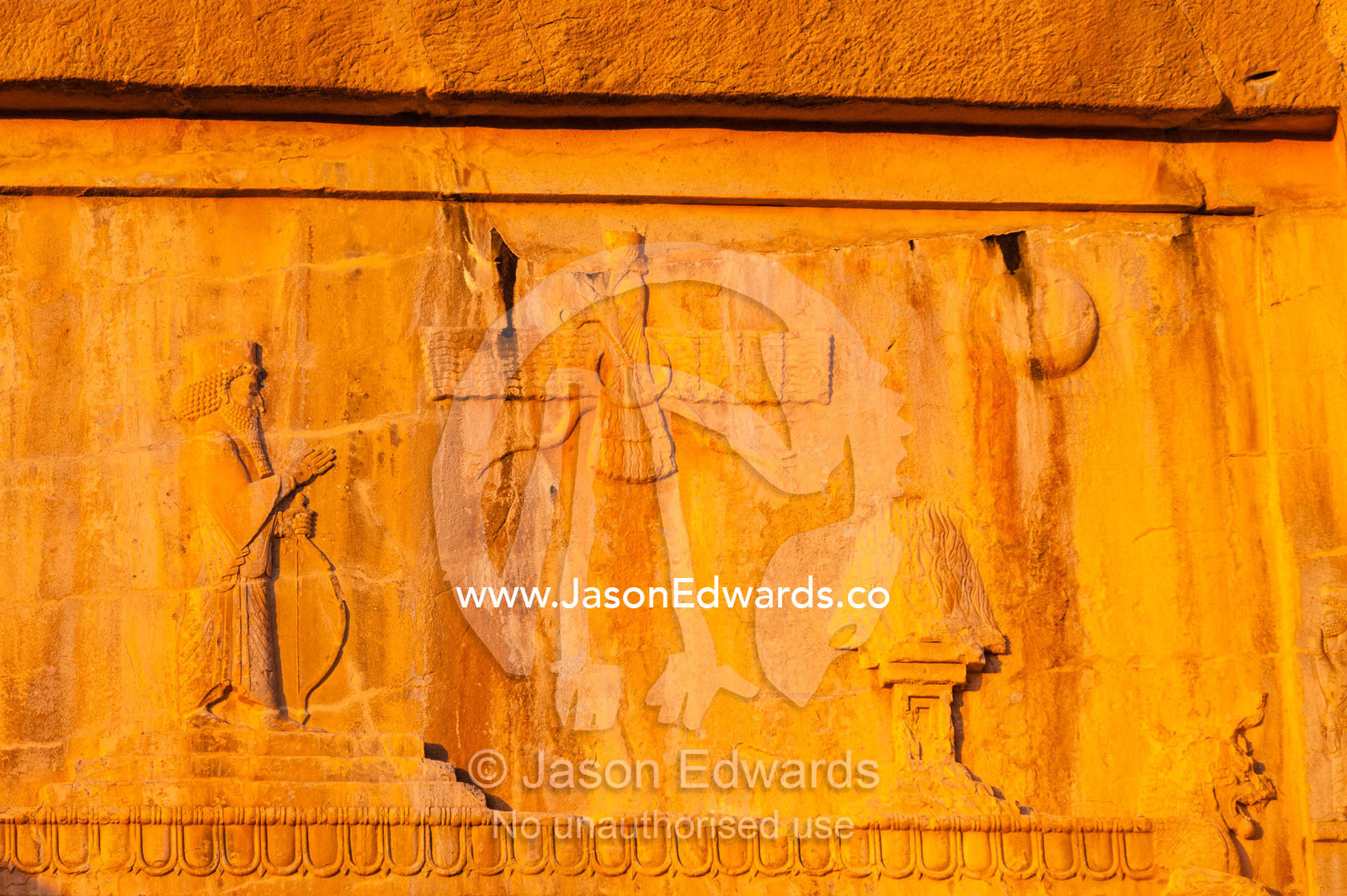 A symbol of the King addressing the winged Fravahr carved into the cliff above the Kings Tomb. Persepolis, Shiraz, Fars Province, Islamic Republic of Iran.