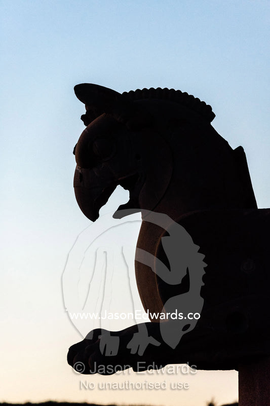 A silhouette of Huma the bird carved in stone at sunset. Persepolis, Shiraz, Fars Province, Islamic Republic of Iran.