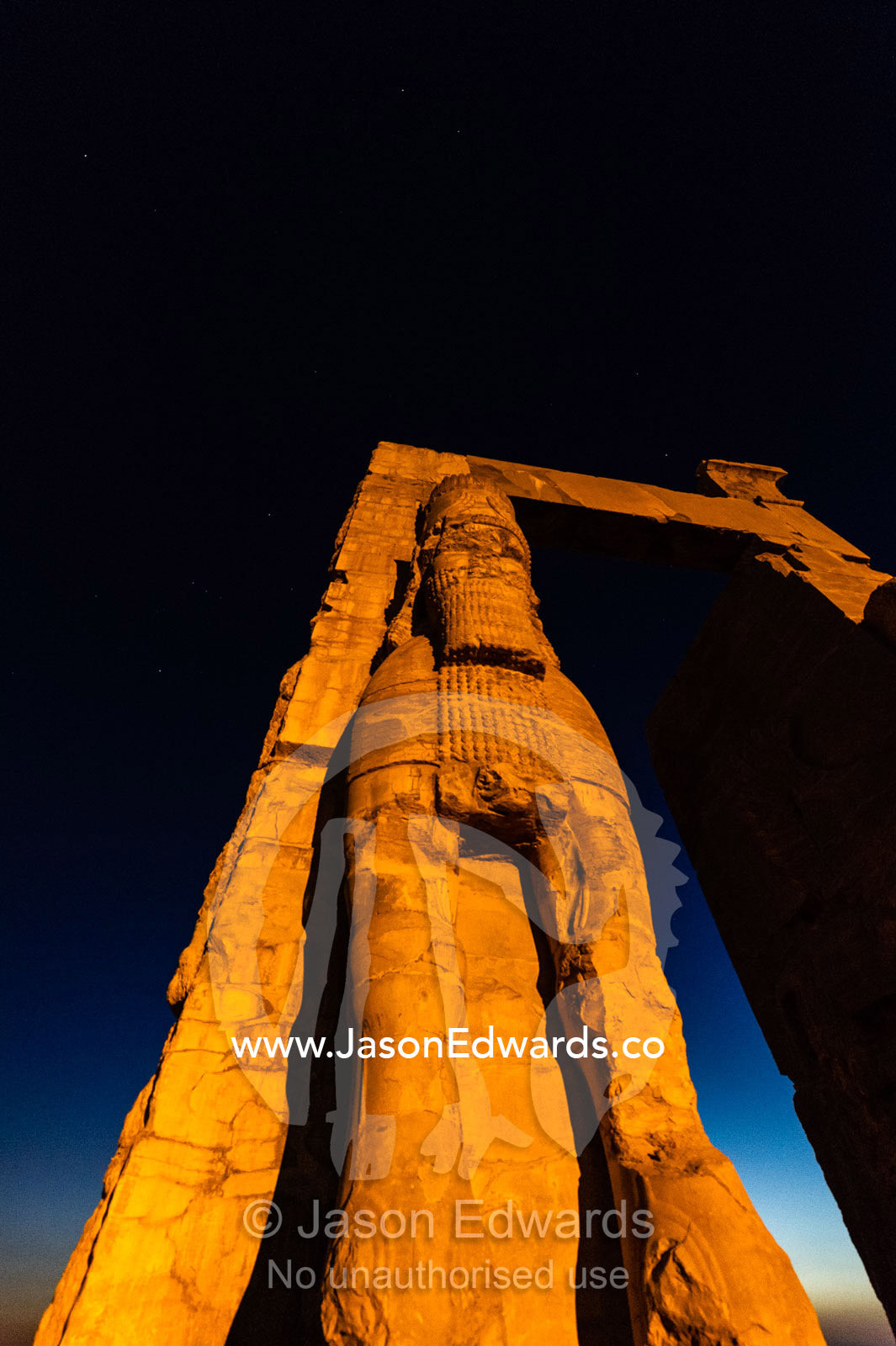 Towering protective gods known as Lamassu at the Gate of All Nations in Persepolis at sunset. Persepolis, Shiraz, Fars Province, Islamic Republic of Iran.