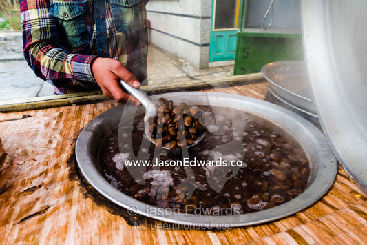 A large cooking pots boiling broad beans in a roadside stall. Tehran, Tehran Province, Islamic Republic of Iran.