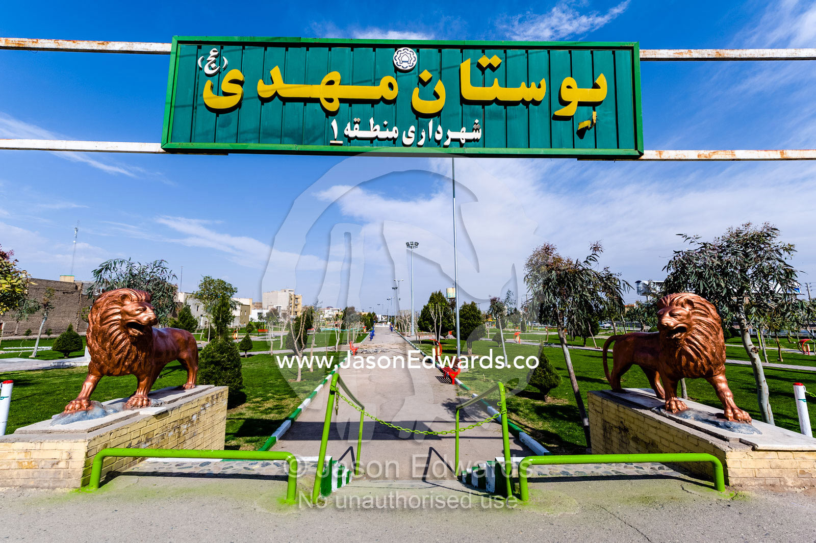 Lion statues stand guard at an entrance to a public park. Qom, Qom Province, Islamic Republic of Iran.